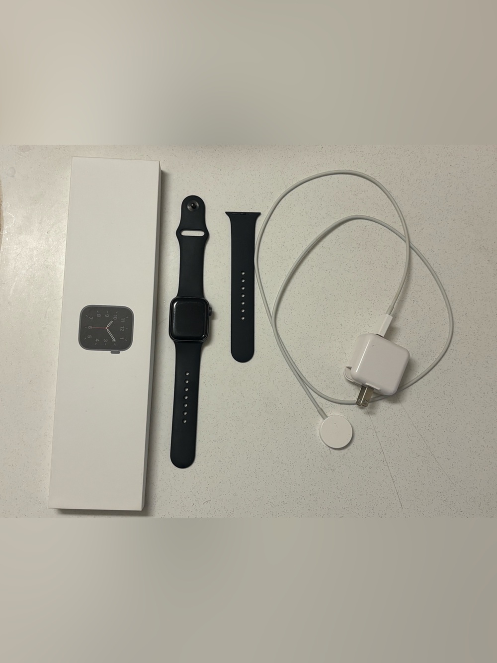 Apple Watch in Black with Black Sport Band and Charger Cable
